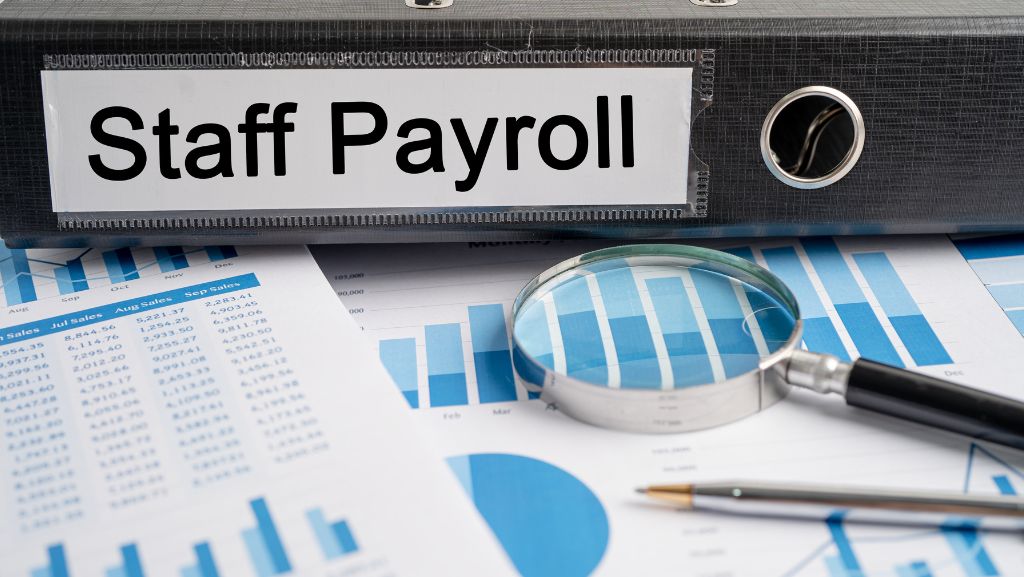 Staff payroll folder on desk with paperwork