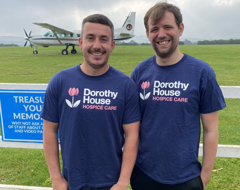 Two men with aeroplane in background