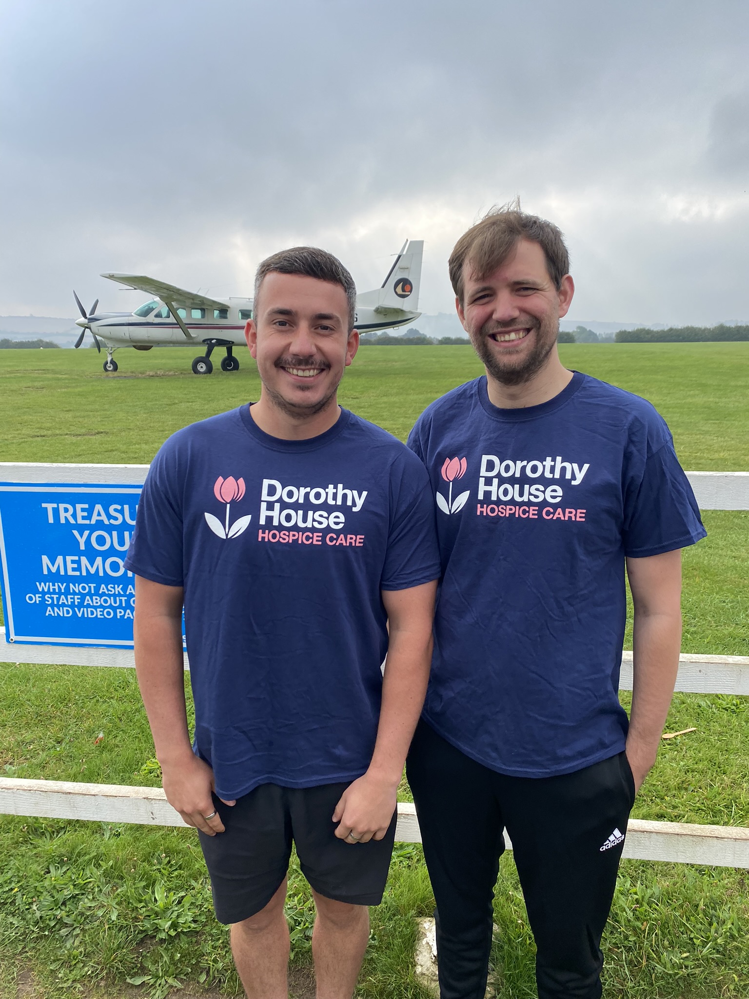 Two men with aeroplane in background