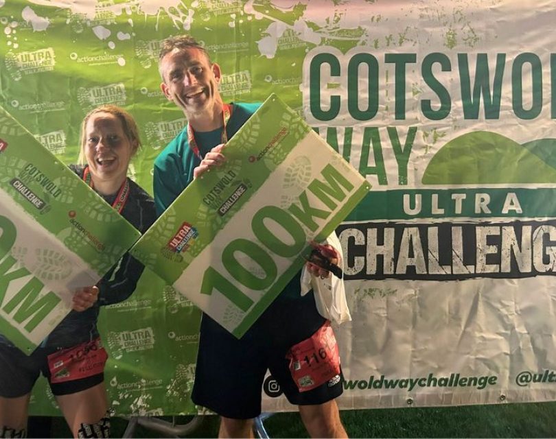 runners holding 100km banner